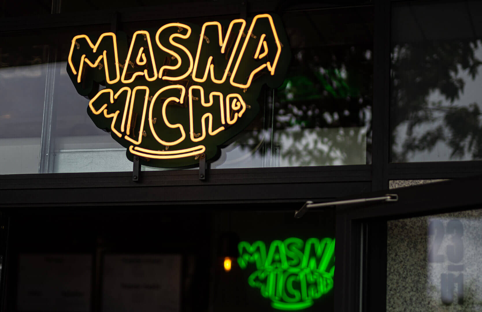 Neon sign for Masna Micha restaurant in Gdansk, outside the premises.